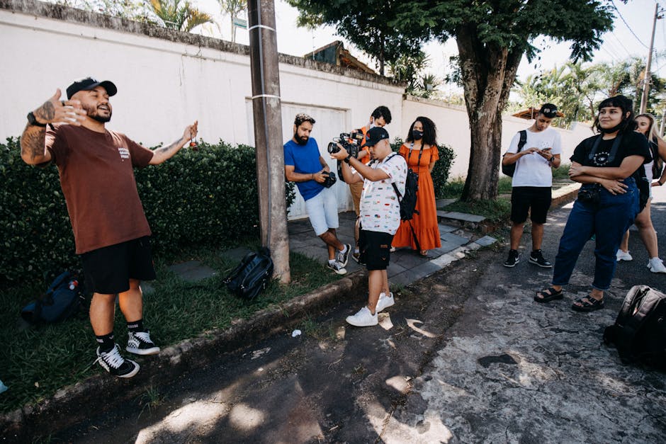 Energetic group of diverse adults in an outdoor photography workshop interacting and learning camera techniques.