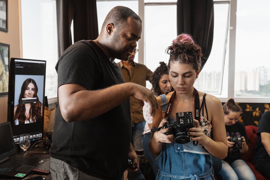 An indoor photography workshop where an instructor guides participants using a DSLR camera.